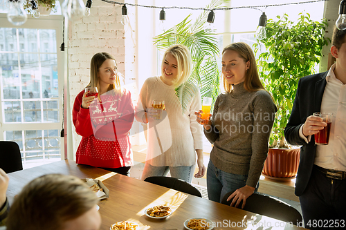 Image of Happy co-workers celebrating while company party and corporate event