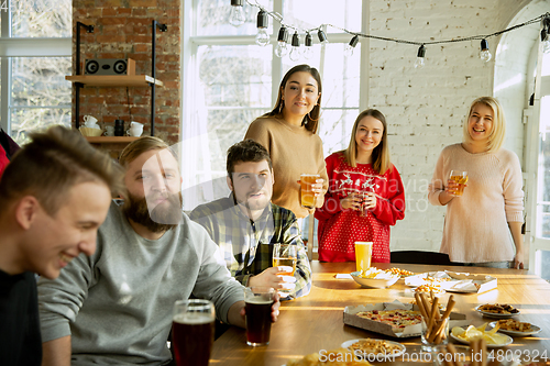 Image of Happy co-workers celebrating while company party and corporate event