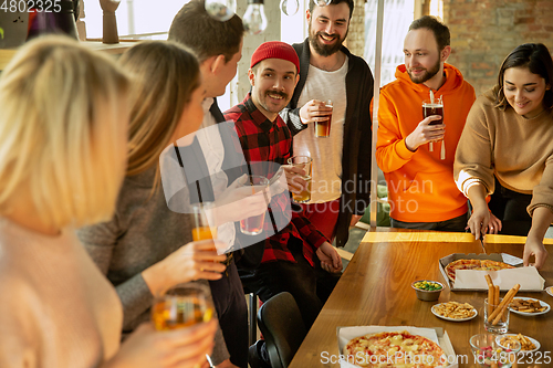 Image of Happy co-workers celebrating while company party and corporate event