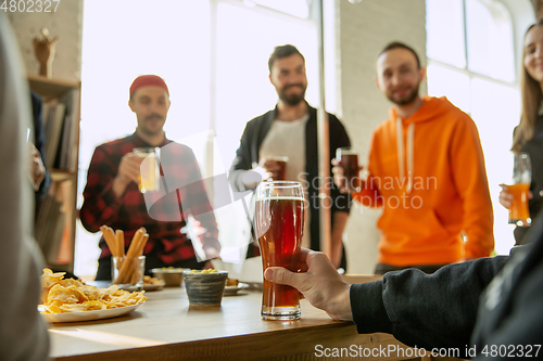 Image of Happy co-workers celebrating while company party and corporate event