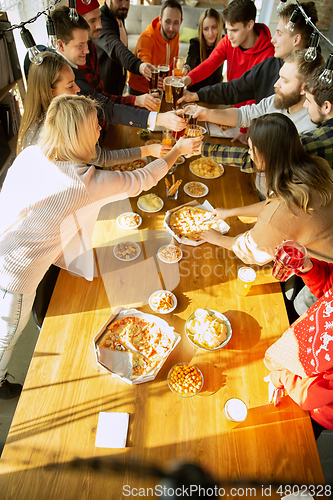 Image of Happy co-workers celebrating while company party and corporate event