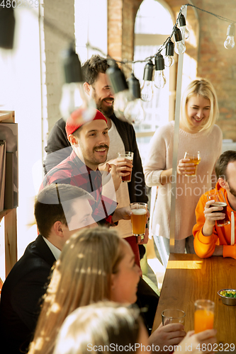 Image of Happy co-workers celebrating while company party and corporate event