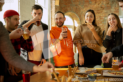 Image of Happy co-workers celebrating while company party and corporate event