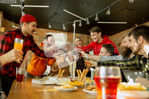 Image of Happy co-workers celebrating while company party and corporate event