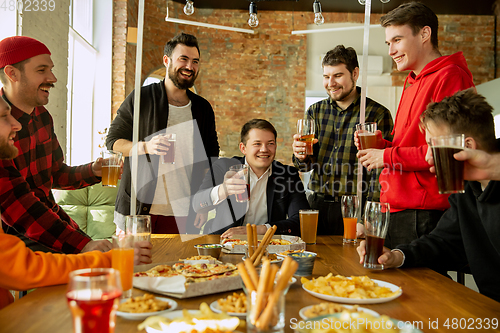 Image of Happy co-workers celebrating while company party and corporate event