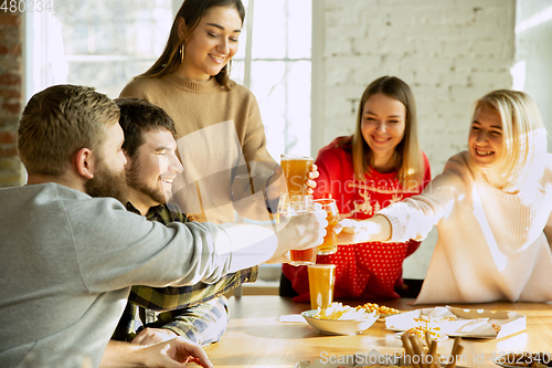 Image of Happy co-workers celebrating while company party and corporate event