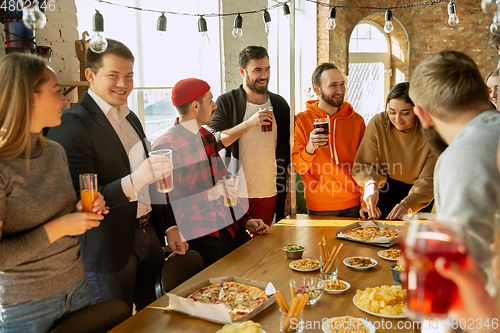 Image of Happy co-workers celebrating while company party and corporate event