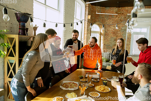 Image of Happy co-workers celebrating while company party and corporate event