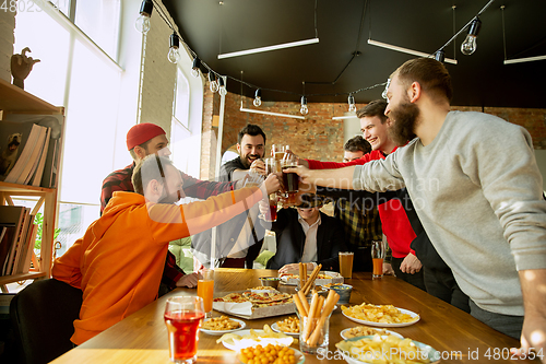 Image of Happy co-workers celebrating while company party and corporate event