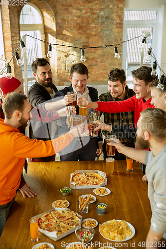 Image of Happy co-workers celebrating while company party and corporate event