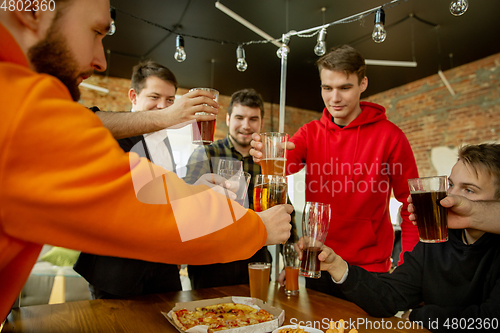 Image of Happy co-workers celebrating while company party and corporate event