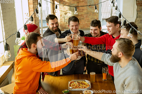 Image of Happy co-workers celebrating while company party and corporate event