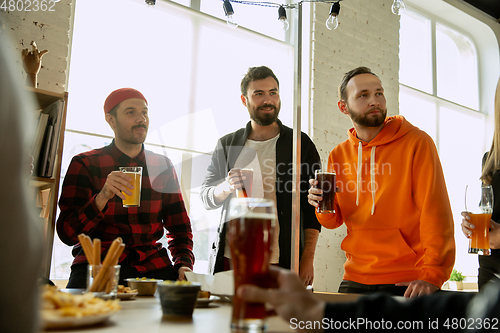 Image of Happy co-workers celebrating while company party and corporate event