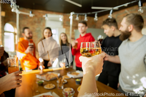 Image of Happy co-workers celebrating while company party and corporate event