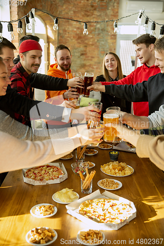 Image of Happy co-workers celebrating while company party and corporate event