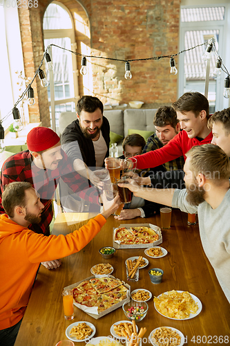 Image of Happy co-workers celebrating while company party and corporate event