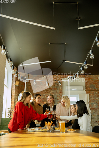Image of Happy co-workers celebrating while company party and corporate event
