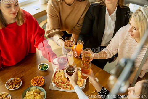 Image of Happy co-workers celebrating while company party and corporate event