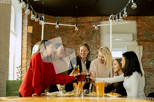 Image of Happy co-workers celebrating while company party and corporate event