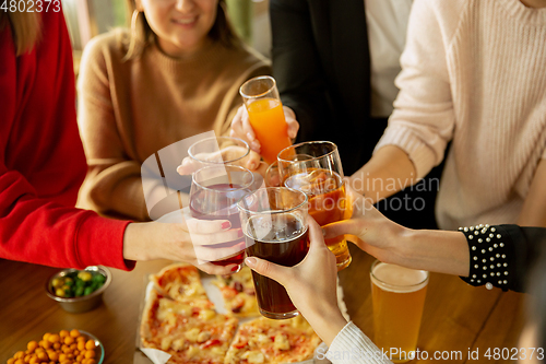 Image of Happy co-workers celebrating while company party and corporate event