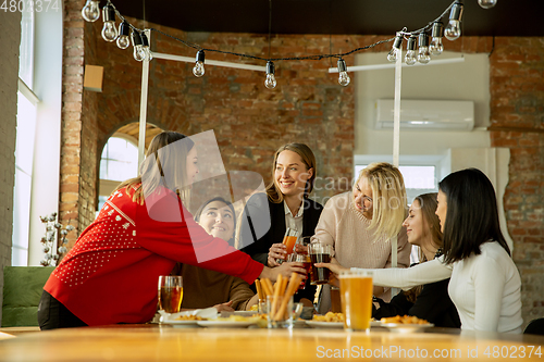 Image of Happy co-workers celebrating while company party and corporate event