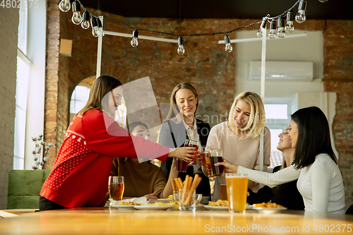 Image of Happy co-workers celebrating while company party and corporate event