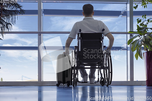 Image of Young man in a wheelchair at the airport 