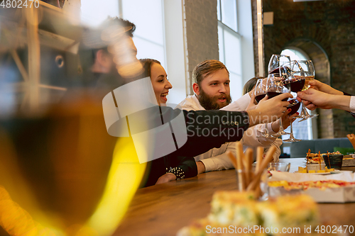 Image of Happy co-workers celebrating while company party and corporate event