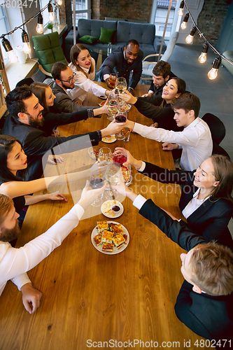 Image of Happy co-workers celebrating while company party and corporate event