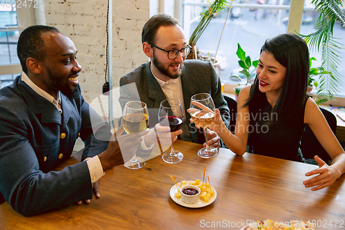 Image of Happy co-workers celebrating while company party and corporate event