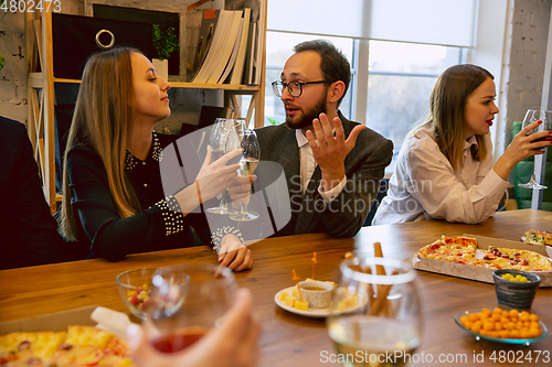 Image of Happy co-workers celebrating while company party and corporate event