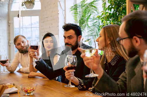 Image of Happy co-workers celebrating while company party and corporate event