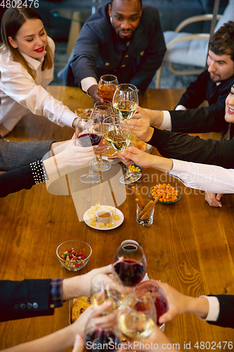 Image of Happy co-workers celebrating while company party and corporate event