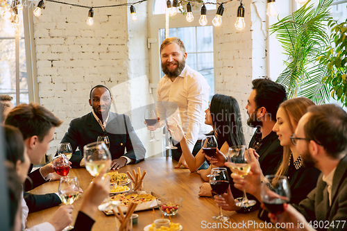 Image of Happy co-workers celebrating while company party and corporate event