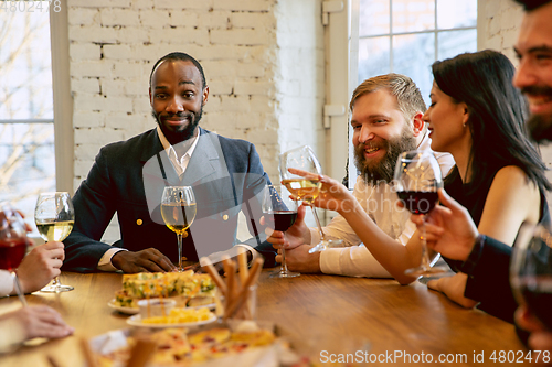 Image of Happy co-workers celebrating while company party and corporate event