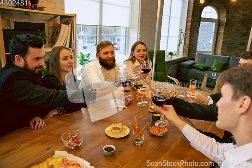 Image of Happy co-workers celebrating while company party and corporate event