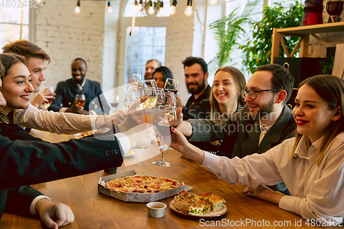 Image of Happy co-workers celebrating while company party and corporate event