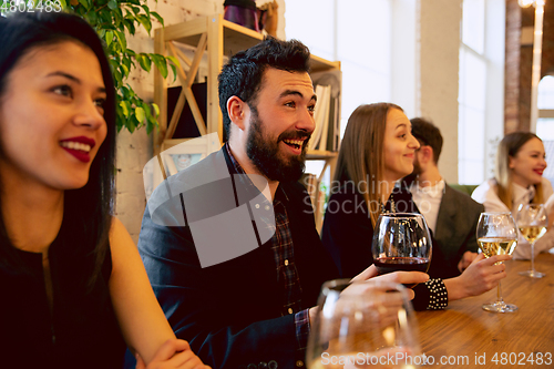 Image of Happy co-workers celebrating while company party and corporate event