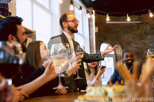 Image of Happy co-workers celebrating while company party and corporate event