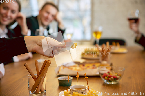 Image of Happy co-workers celebrating while company party and corporate event