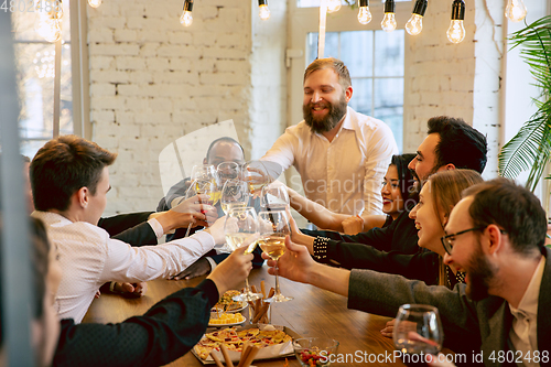 Image of Happy co-workers celebrating while company party and corporate event