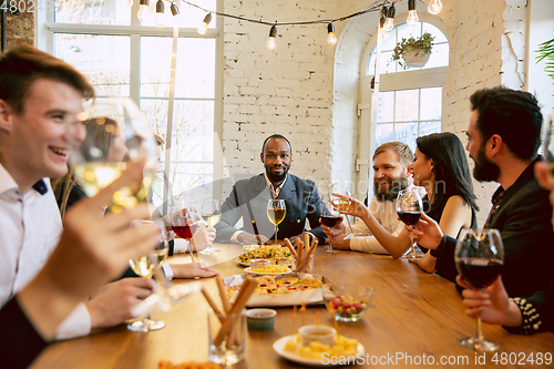 Image of Happy co-workers celebrating while company party and corporate event