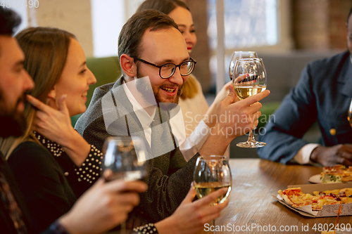 Image of Happy co-workers celebrating while company party and corporate event