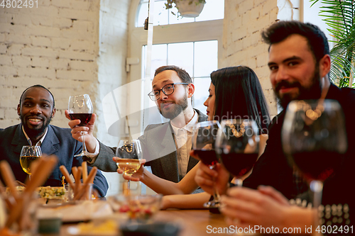 Image of Happy co-workers celebrating while company party and corporate event