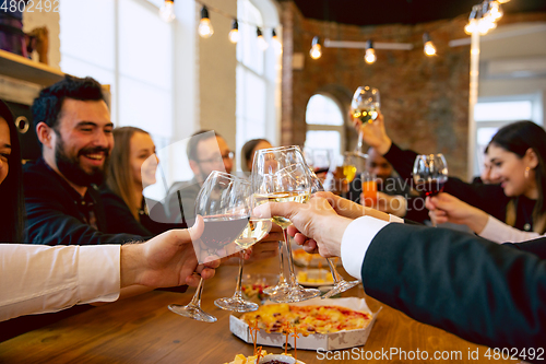 Image of Happy co-workers celebrating while company party and corporate event