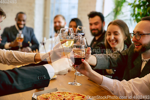 Image of Happy co-workers celebrating while company party and corporate event