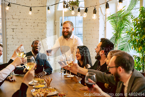 Image of Happy co-workers celebrating while company party and corporate event