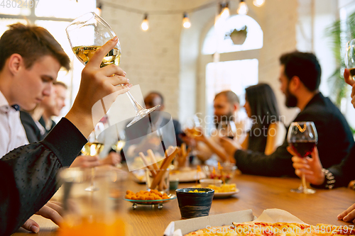 Image of Happy co-workers celebrating while company party and corporate event