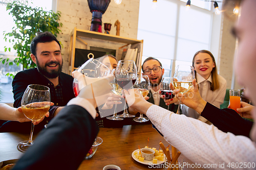 Image of Happy co-workers celebrating while company party and corporate event