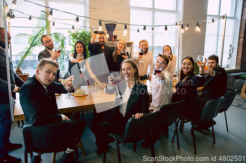 Image of Happy co-workers celebrating while company party and corporate event